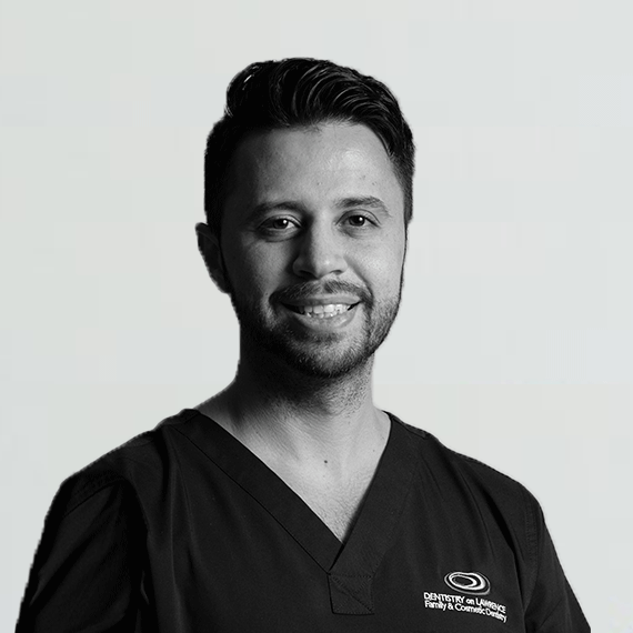 An image of a dentist smiling.