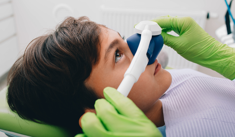 Dentist offering sedation explaining safe procedures at Dentistry on Lawrence